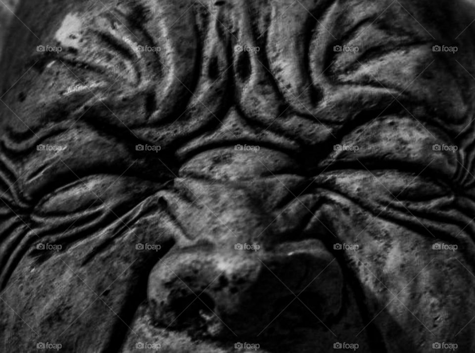 angry stone gargoyle close up