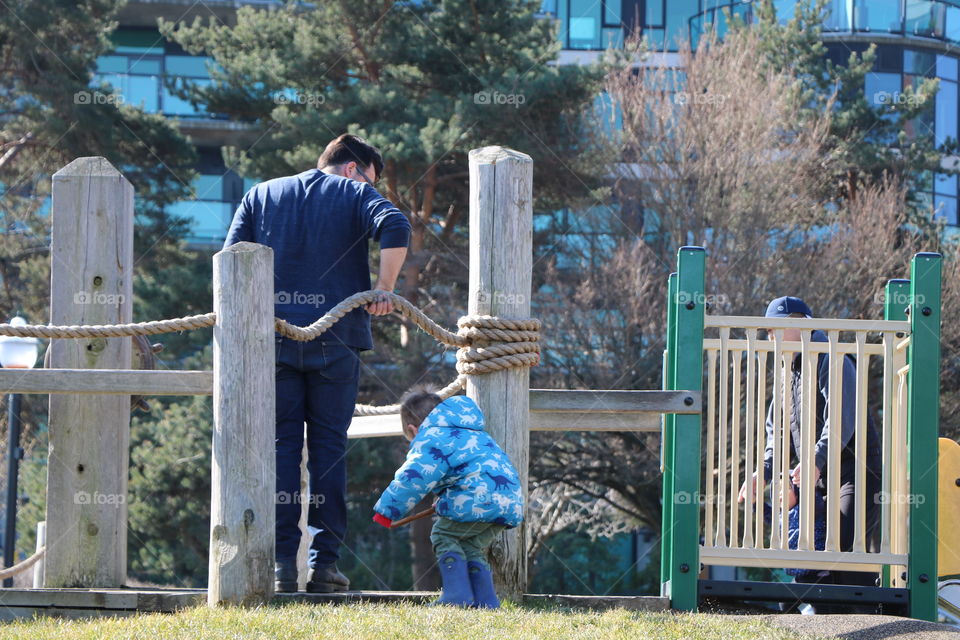 Father and son playing on a playground 