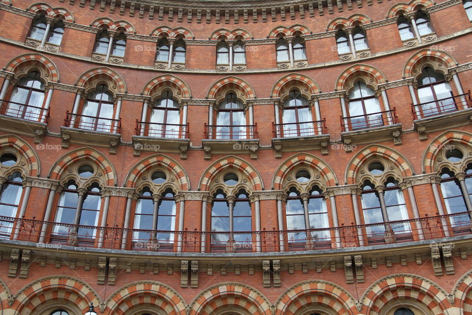 The red brick facade of The St Pancras Renaissance Hotel building in King's Cross, London.