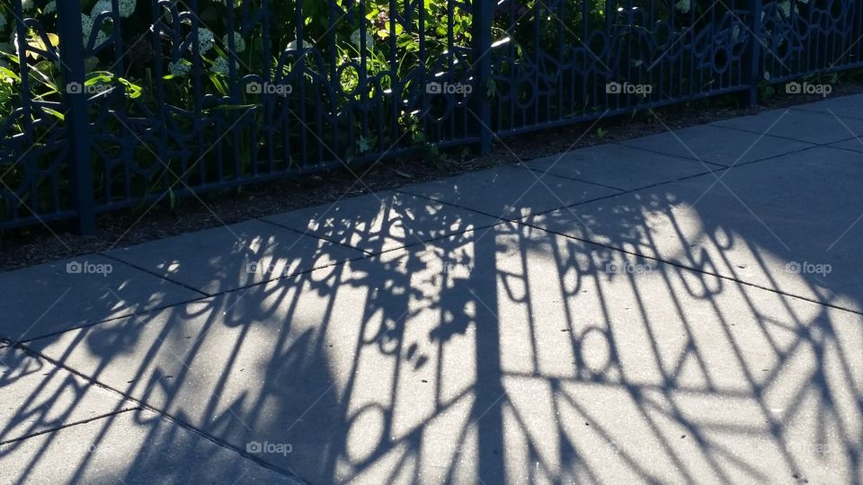 fencer own shadow on a sidewalk