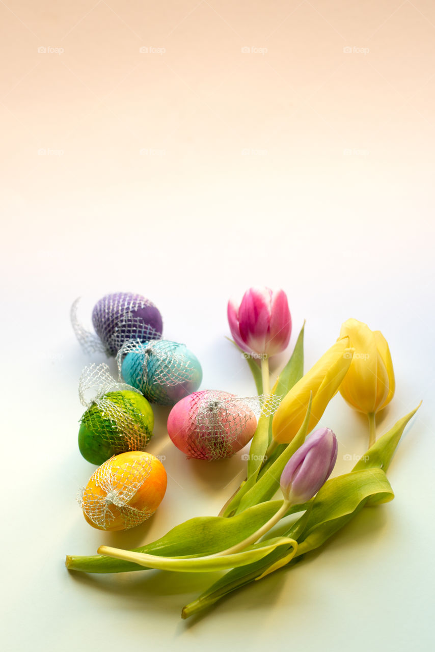 Easter time, spring flowers and colored eggs