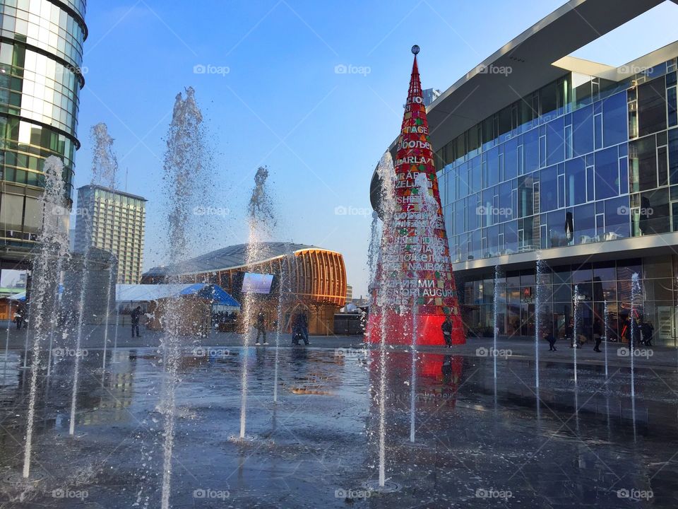 beautiful and strange fountain between the buildings of Milan in the Christmas time