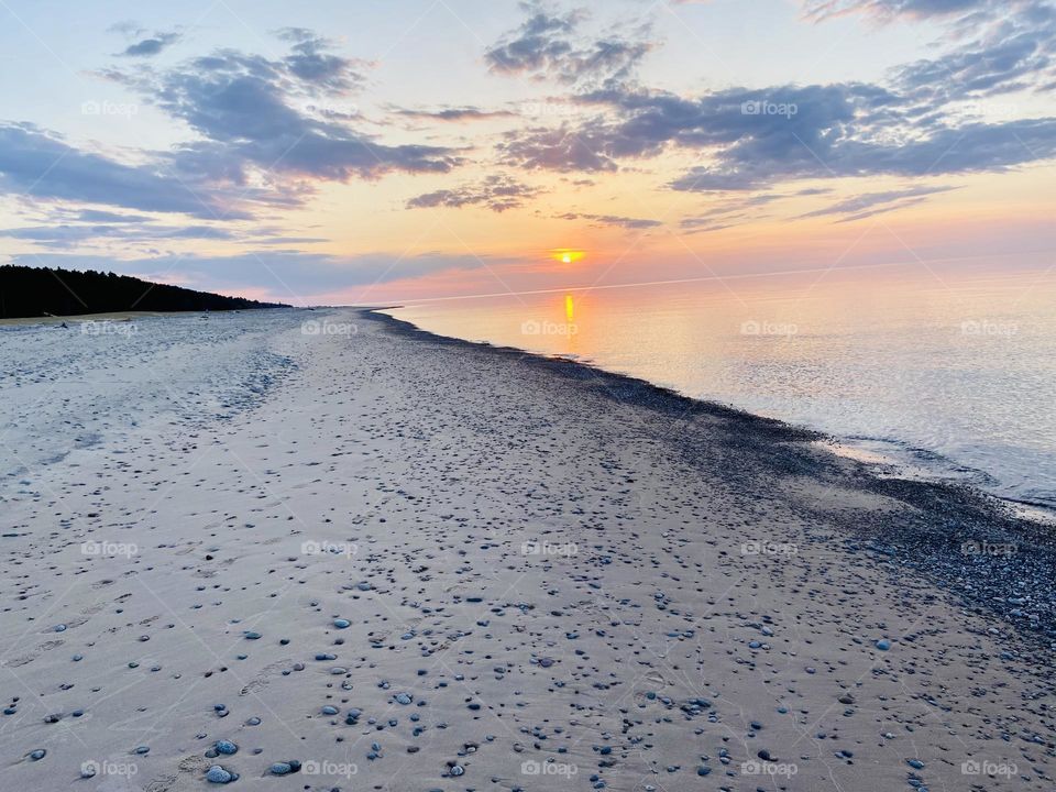 A sunset on a Sandy beach on the shores of Lake Superior in the upper peninsula of Michigan