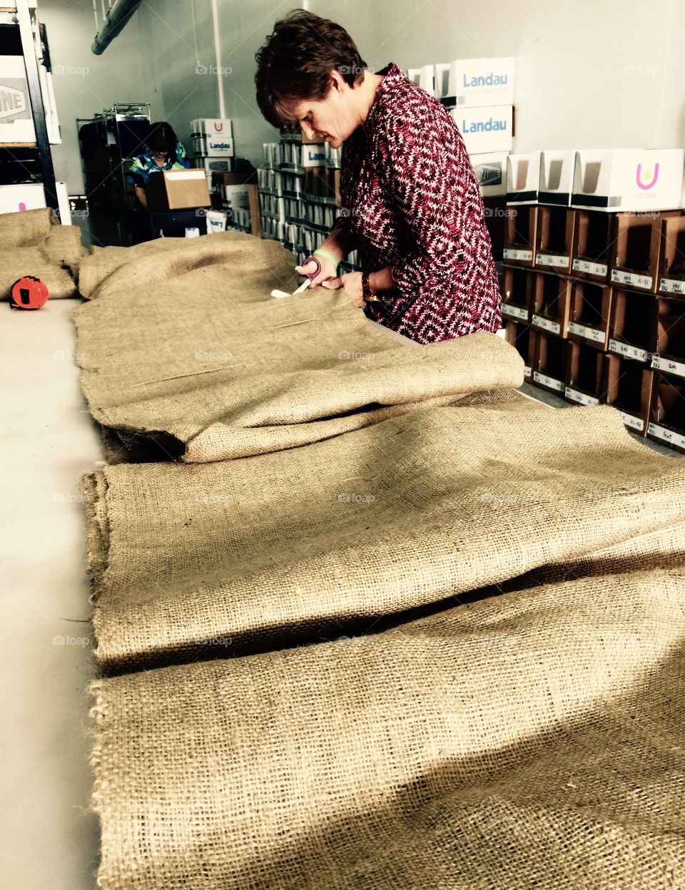 Woman cutting textile in factory