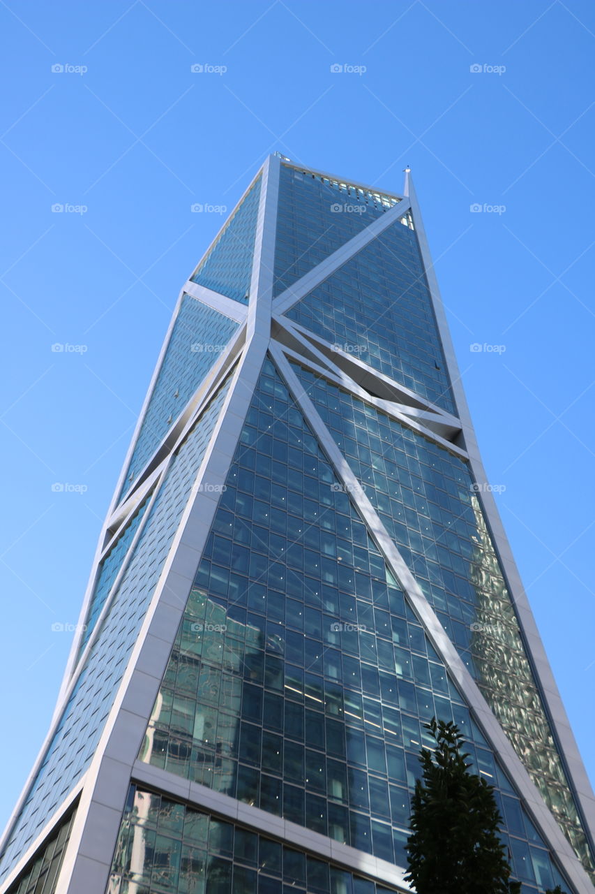 Blue skyscraper heading up on the blue sky- monochromatic 