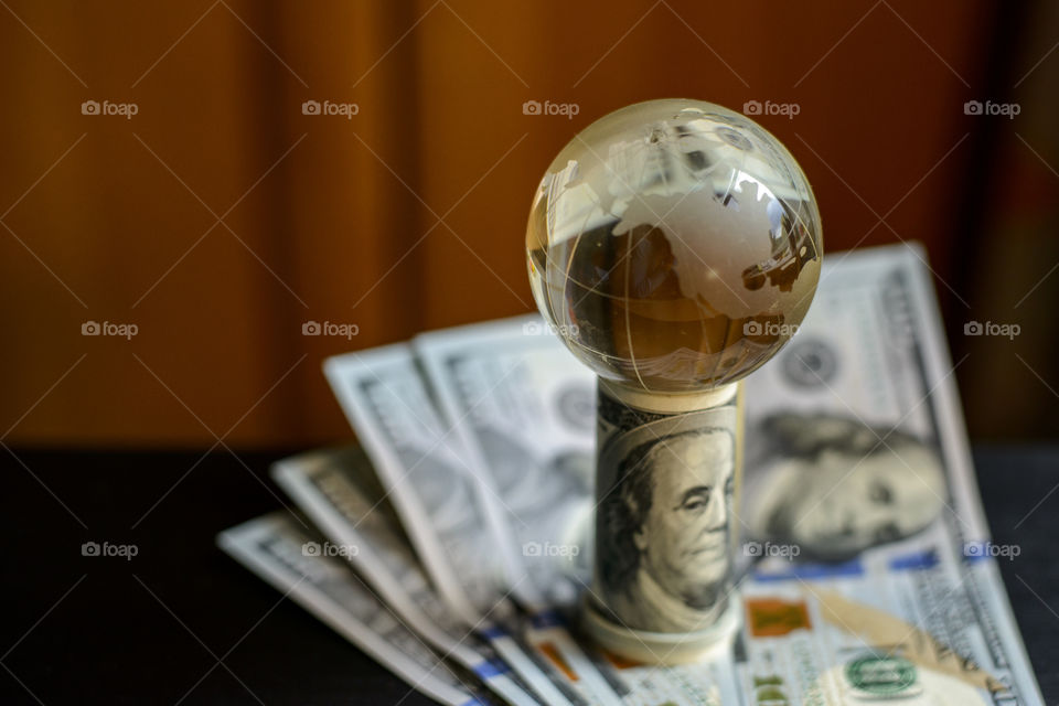 transparent globe on dollars