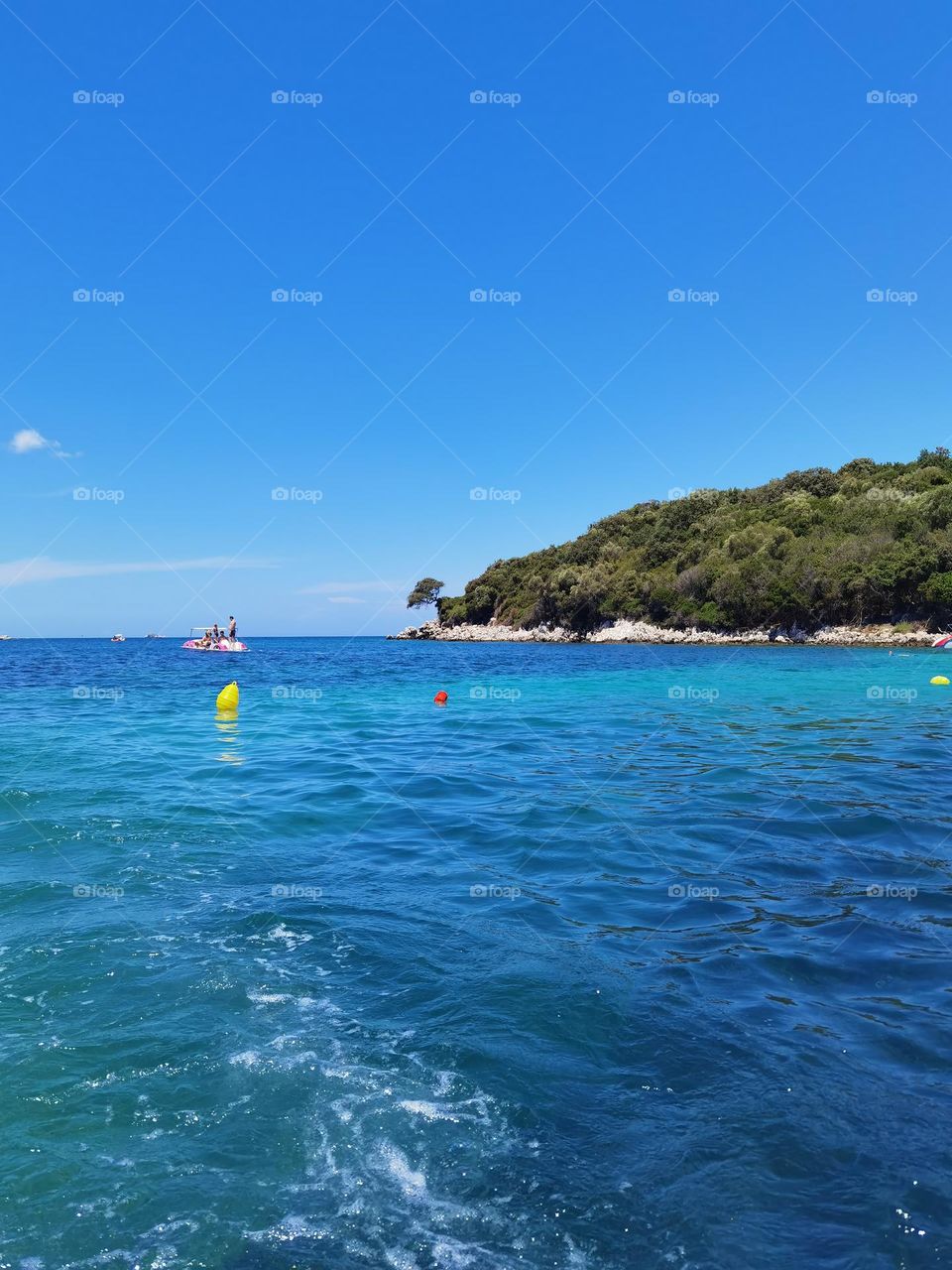 Piece of land in the sea. Summer day spent swimming the sea.