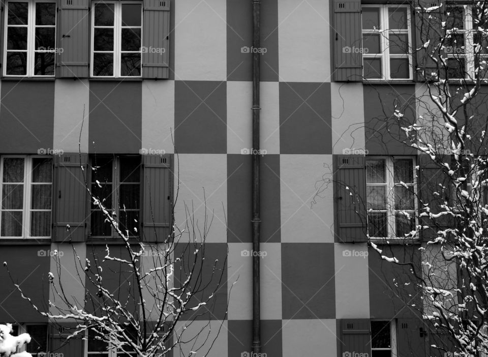 Black and white shot of building exterior during winter in Berlin, Germany.