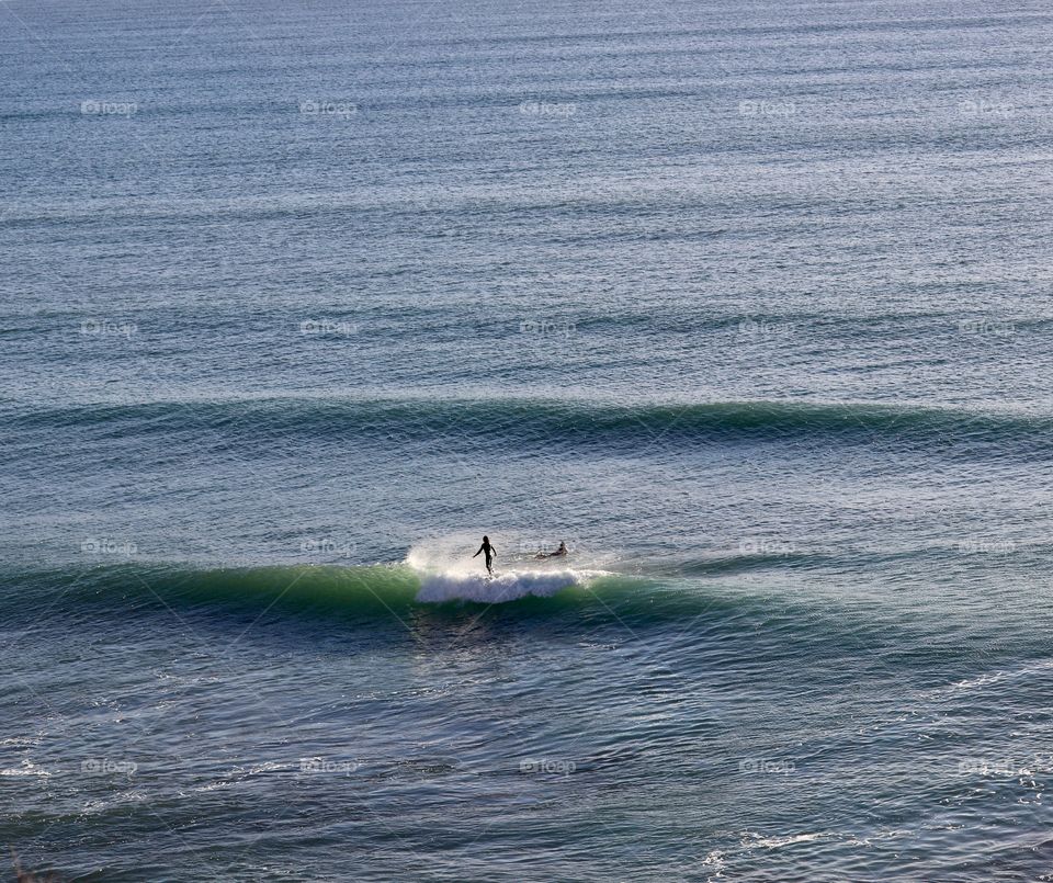Surfers in South Australia, view from a cliff looking over the ocean, Great Australian Bight, concept travel and tourism, vacations, water sports, daredevils, freedom, minimalism, copy and text space