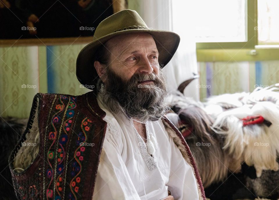 Old man with beard and wearing a traditional romanian costume, from the Maramures region.