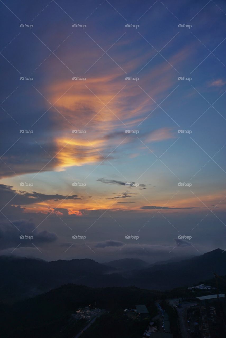 Sunrise at Genting Highlands. Rays of suns on the waves of clouds above of Genting Higlands in Malaysia