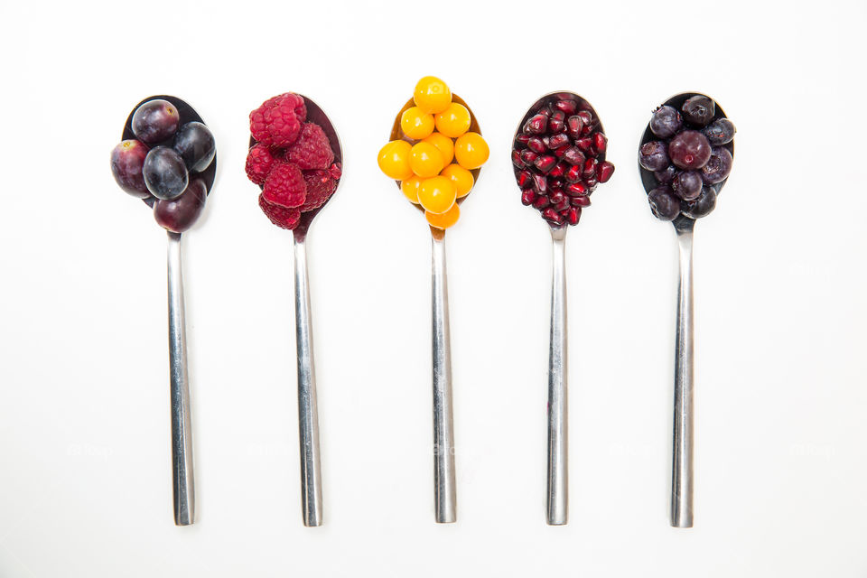 Flat lay of different fresh and healthy summer fruit on a white background. I love eating fresh fruits to improve my health and nutrient intake.