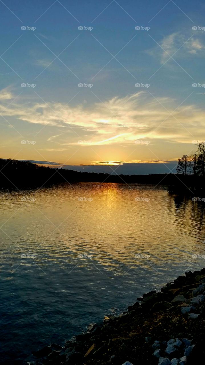 sun behind clouds during sunset