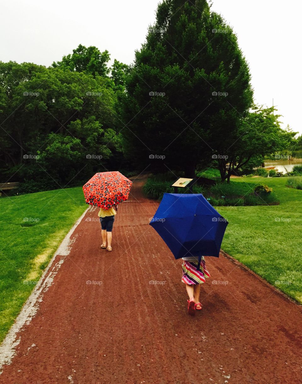 Walking in the rain. Little girls walking in the rain