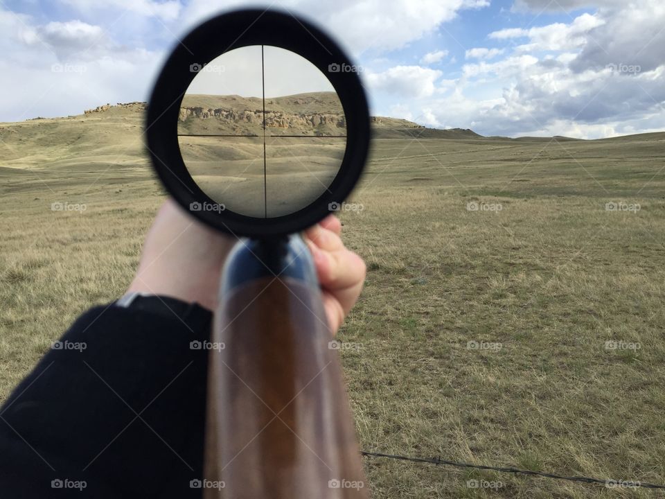 A hill is magnified through a rifle scope in the Montana wilderness. 