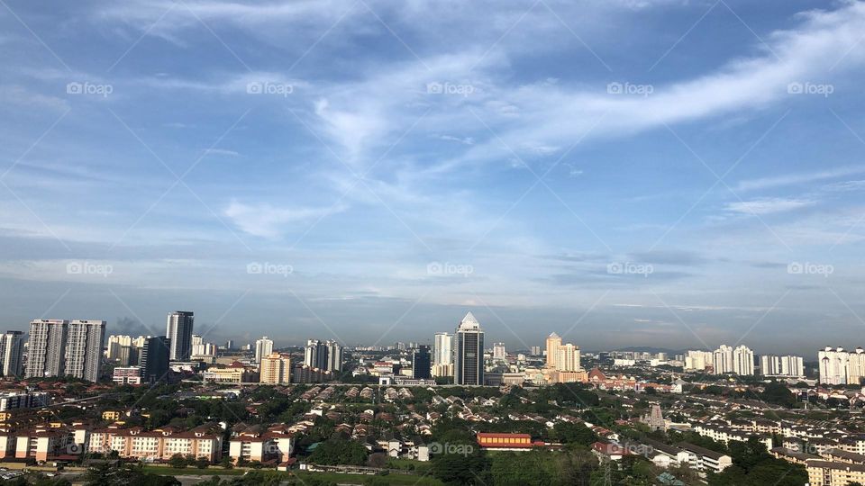 Beautiful blue sky, clouds and cityscape. 