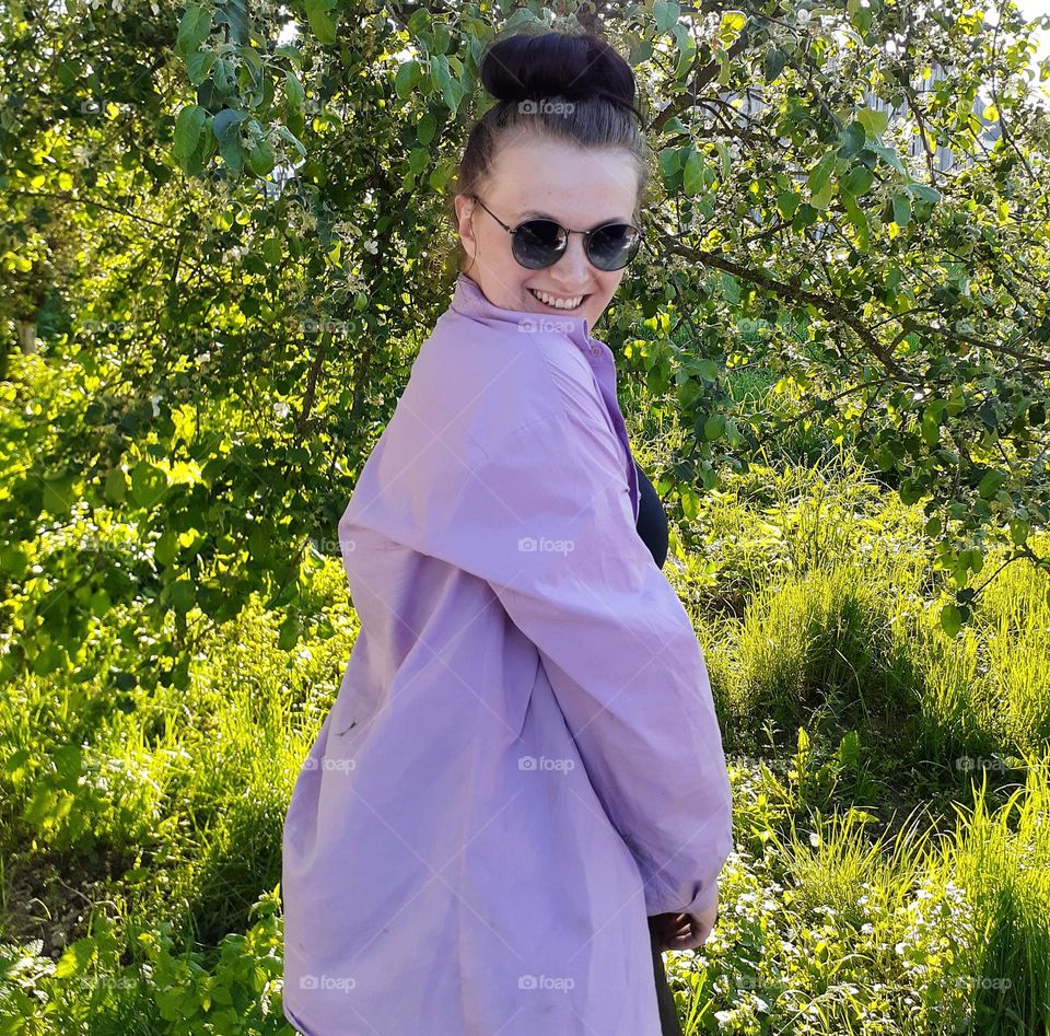 The girl is wearing a lavender shirt