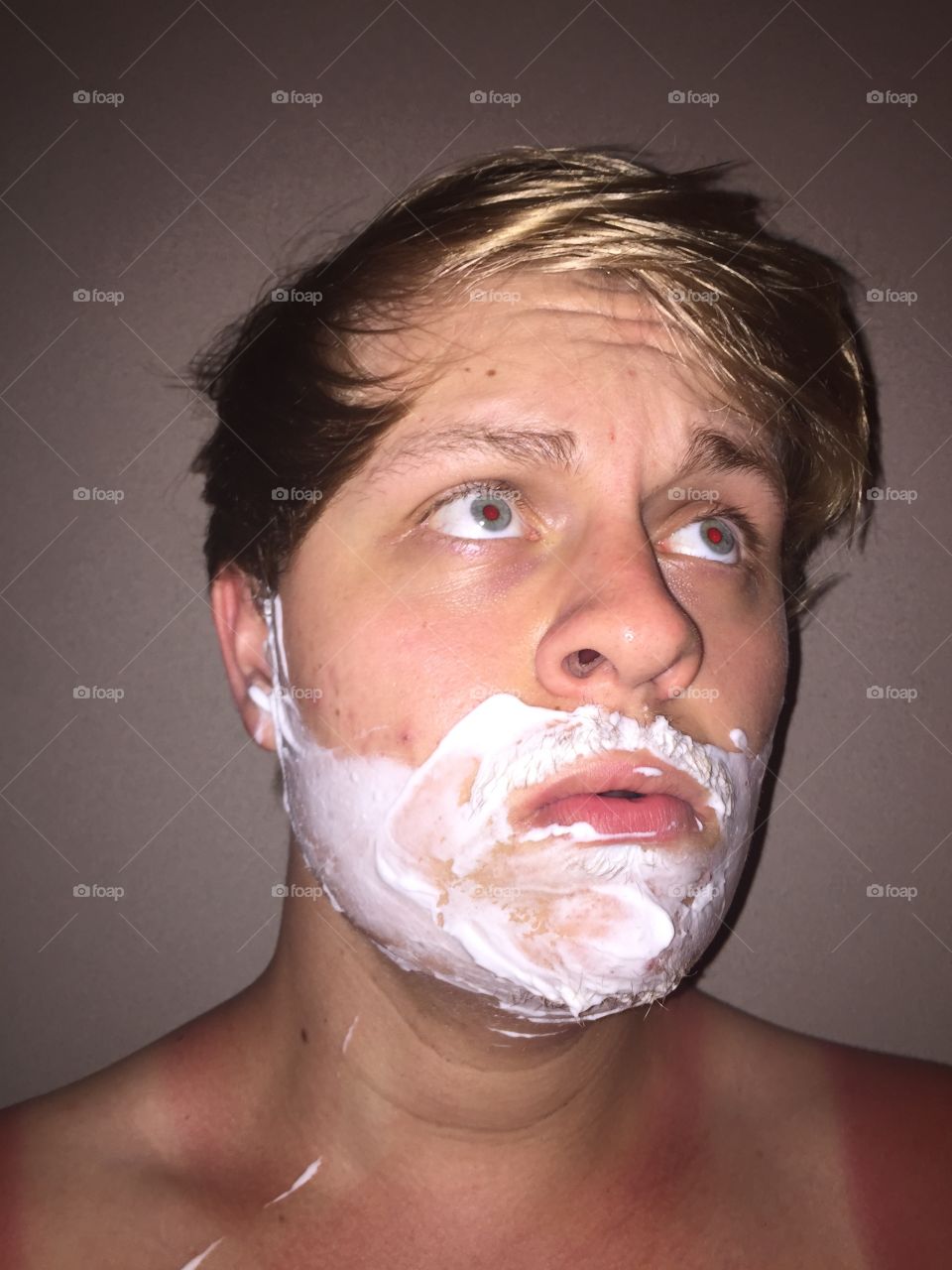I’m taking a selfie with shaving cream on my face.
