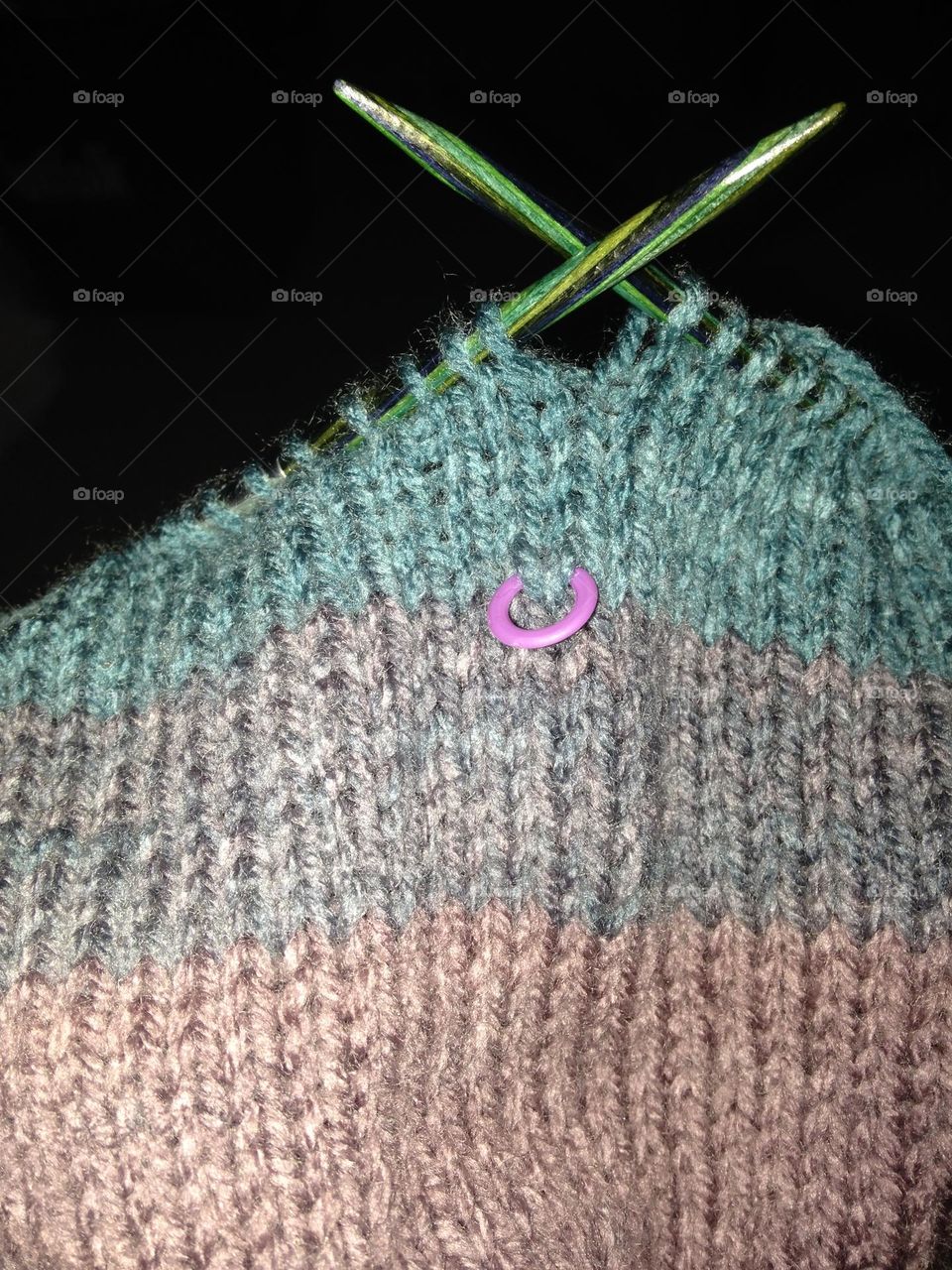 Oops-stitch marker captured in striped knitting