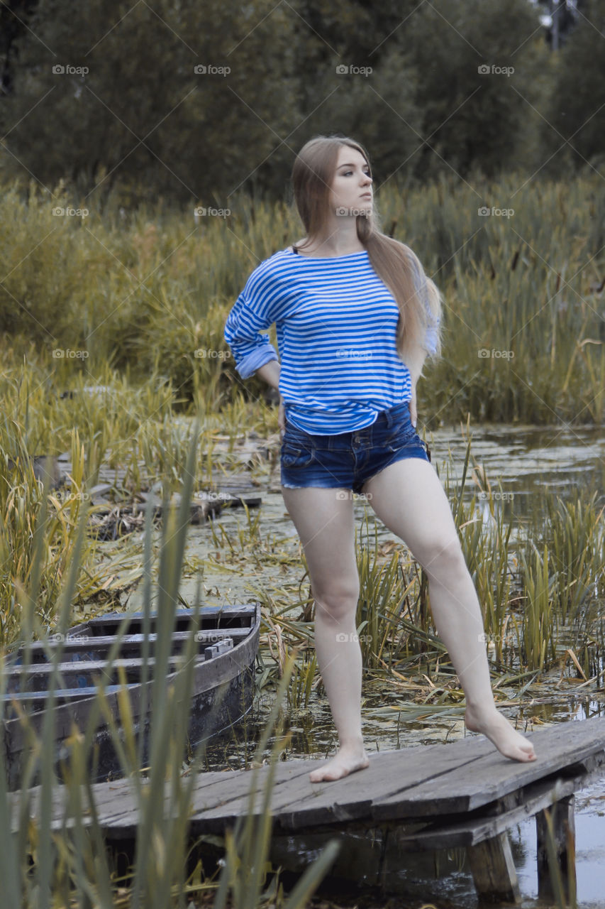 A girl with blond hair on the lake in a striped shirt and short denim shorts on the background of grass, reeds and an old wooden boat
Girl, woman, man, blonde, blonde hair, striped shirt, short shorts, denim shorts, shore, lake, grass, reeds, old boat, feelings, emotions, tenderness, love, lifestyle, lifestyle, vacation