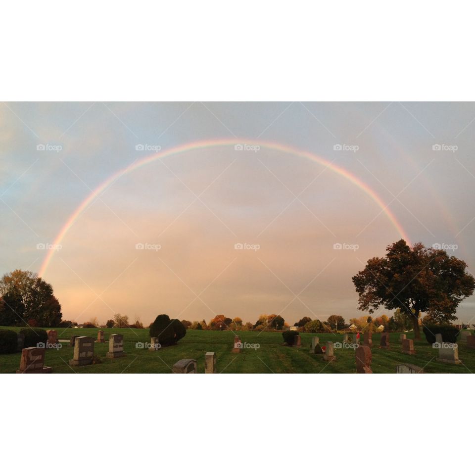 Sunset and double rainbow at cemetery in Syracuse, NY