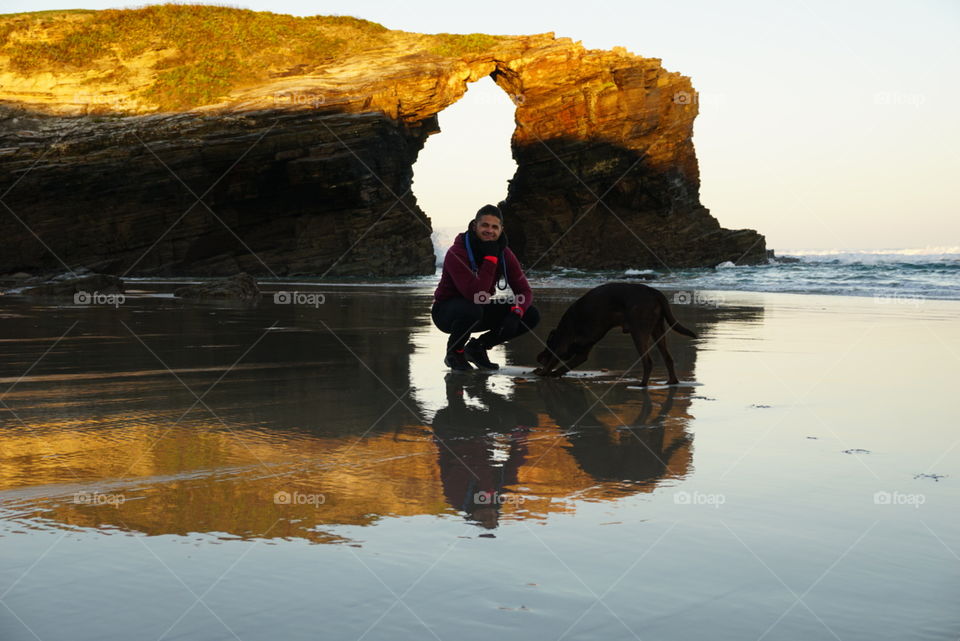 Beach#rocks#reflect#human#dog#ocean