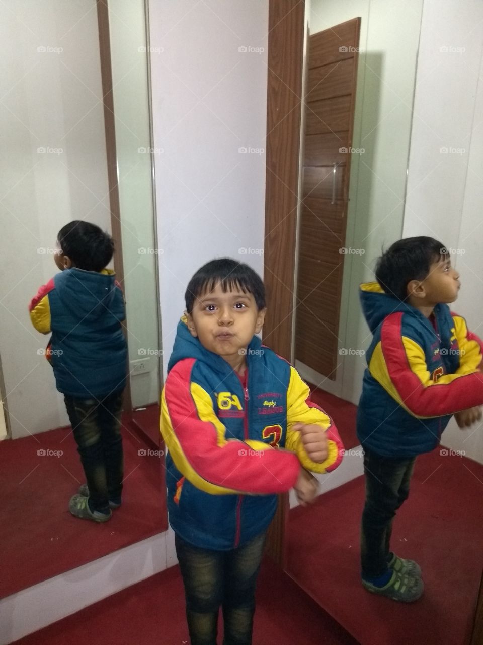 kid making faces in mirror
