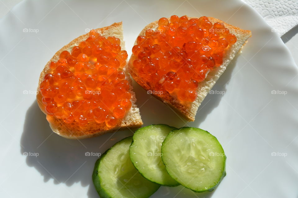 sandwiches with red caviar on a plate