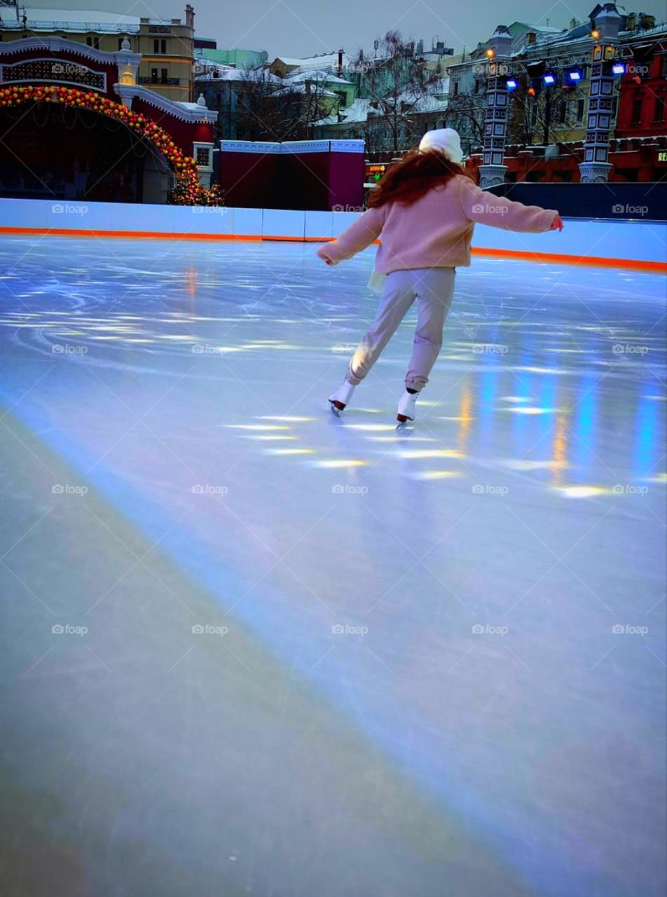 Fiery dance on ice. Winter. Figure skater dances on open ice