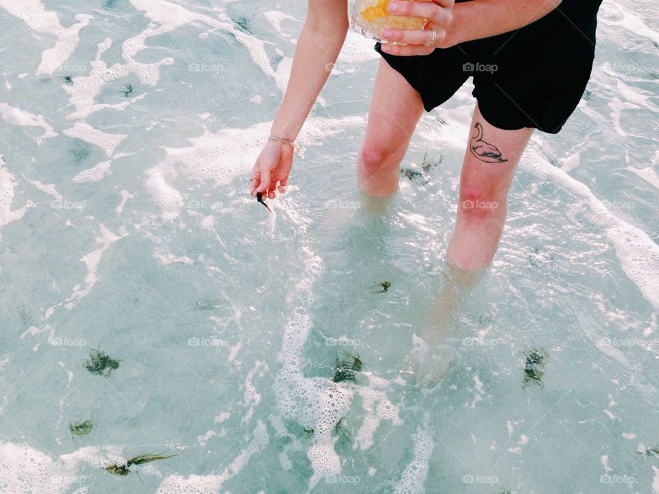 Beach legs. Blue water, Gulf of Mexico, tattoo, whiskey, beach life, Florida 