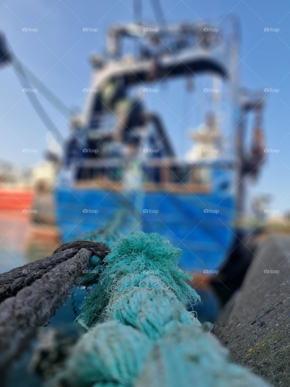 fishing boat moored with a rope in the port