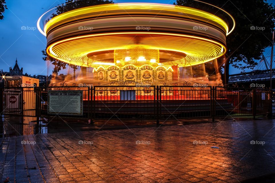Rainy night ride. On the banks of the Thames in London is a quite piece of park with a single carousel. I took this on a rainy night. 
