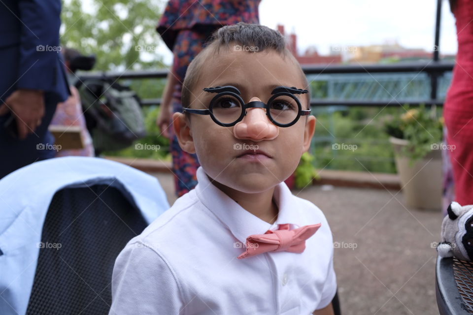 Boy with disguise at wedding celebration 