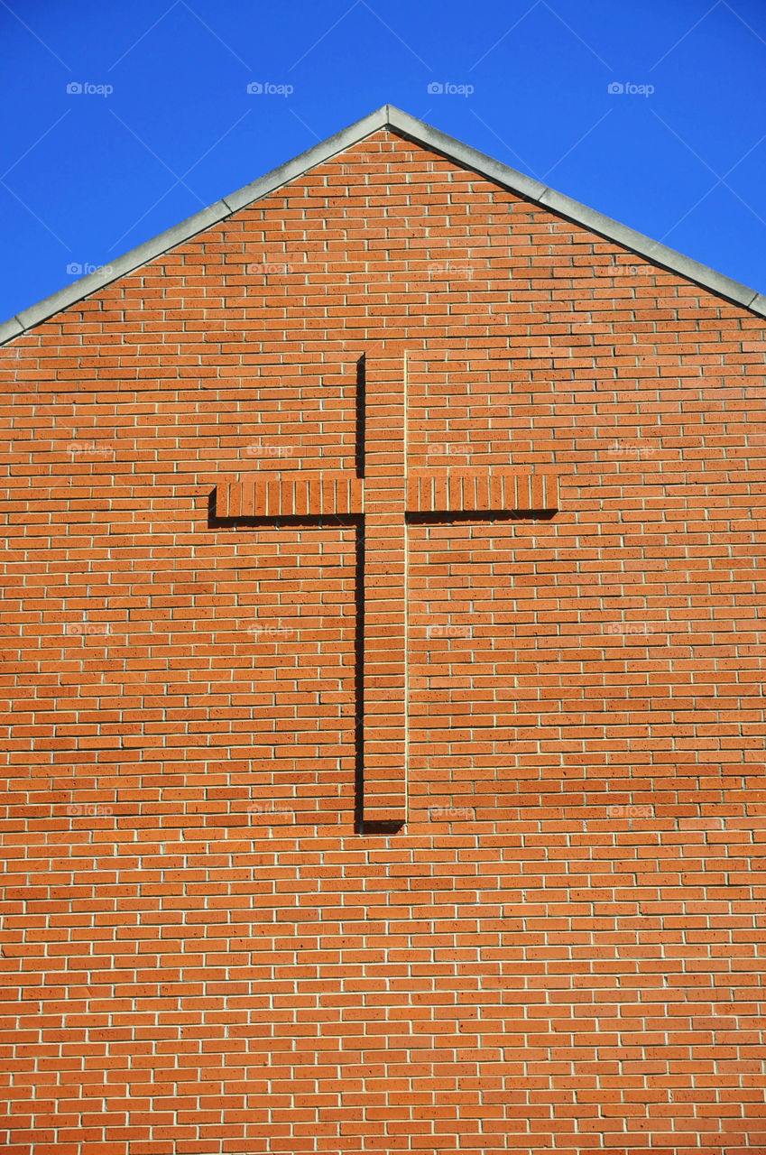 Church. Brick wall of a church with a cross on it