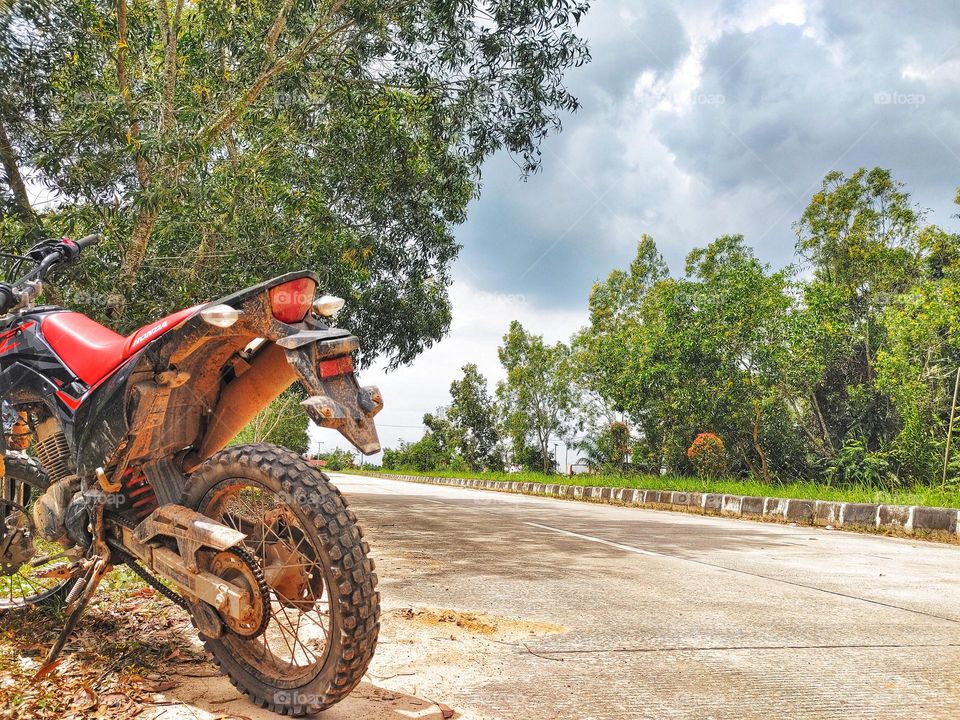 motorcycle wheels full of mud after traveling in the forest