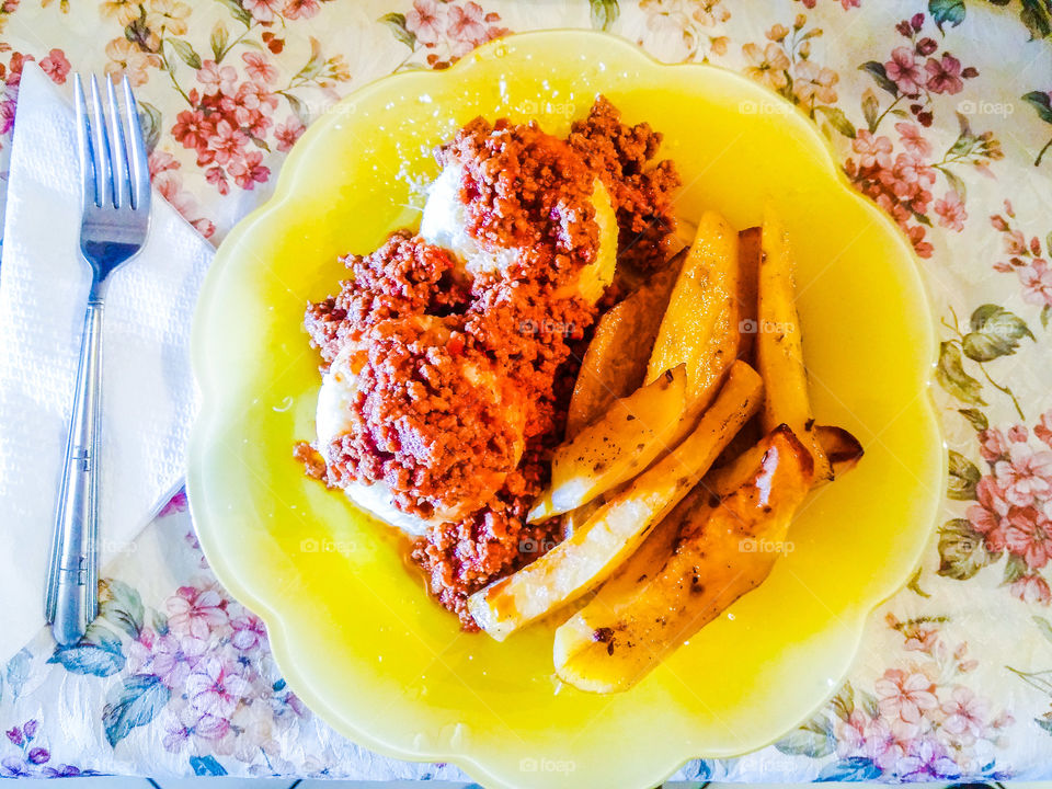 plate with rice, minced meat,  potatoes and parmesan cheese