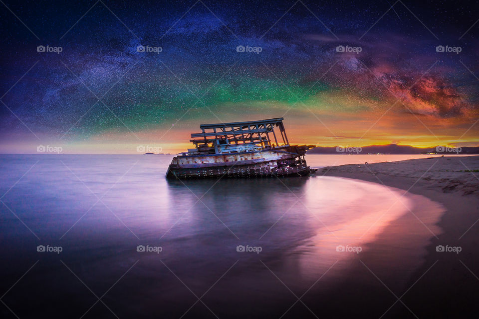 wreck on the beach and milky way