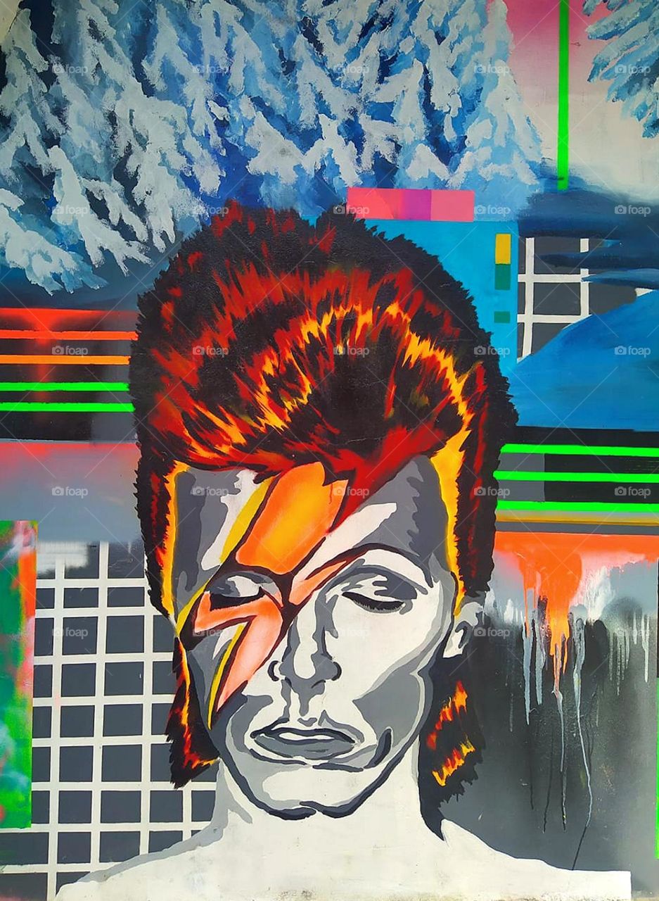 Anger. Graffiti. A woman's face is painted on the wall, which is crossed by lightning bolts. Facial expressions, colors and lightning show anger