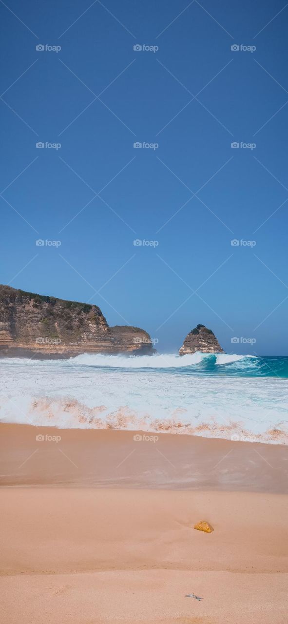 A beach with beautiful waves and clean sand