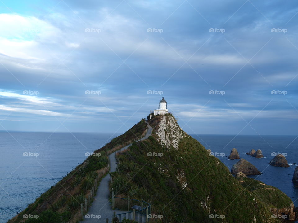 clouds over the lighthouse in new Zealand