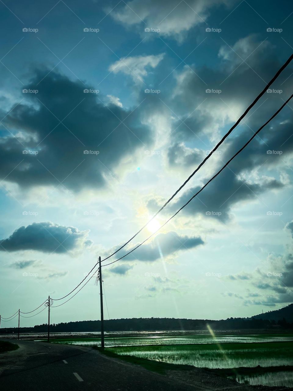 Cloudy grey sky and electricity lines on an open area