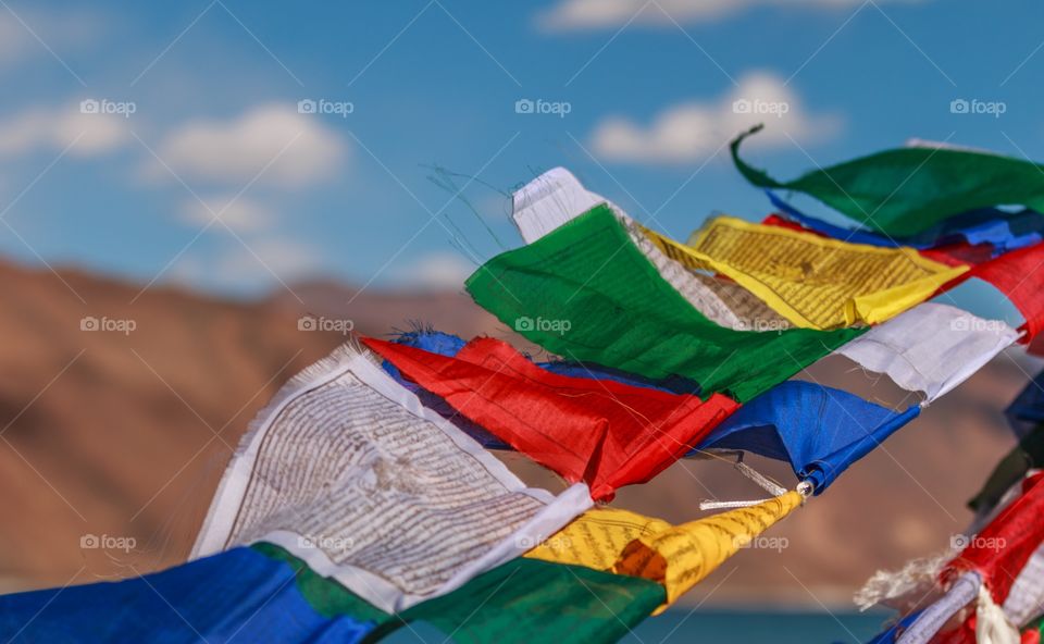 colorful Buddhist prayer flags flying over the mountains