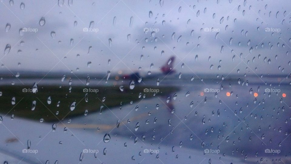 Rain on runway with Virgin America plane on runway, SFO, San Francisco, CA.