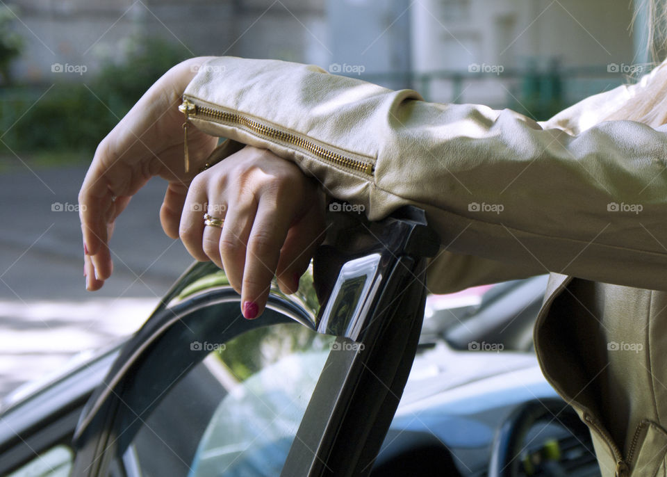 Girl driving a car in a golden jacket