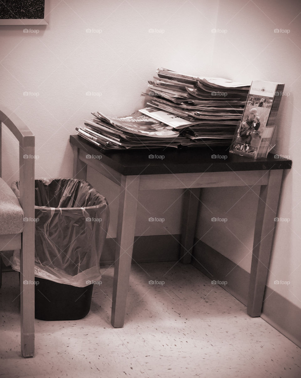 magazine stand in the doctors office with a teach can