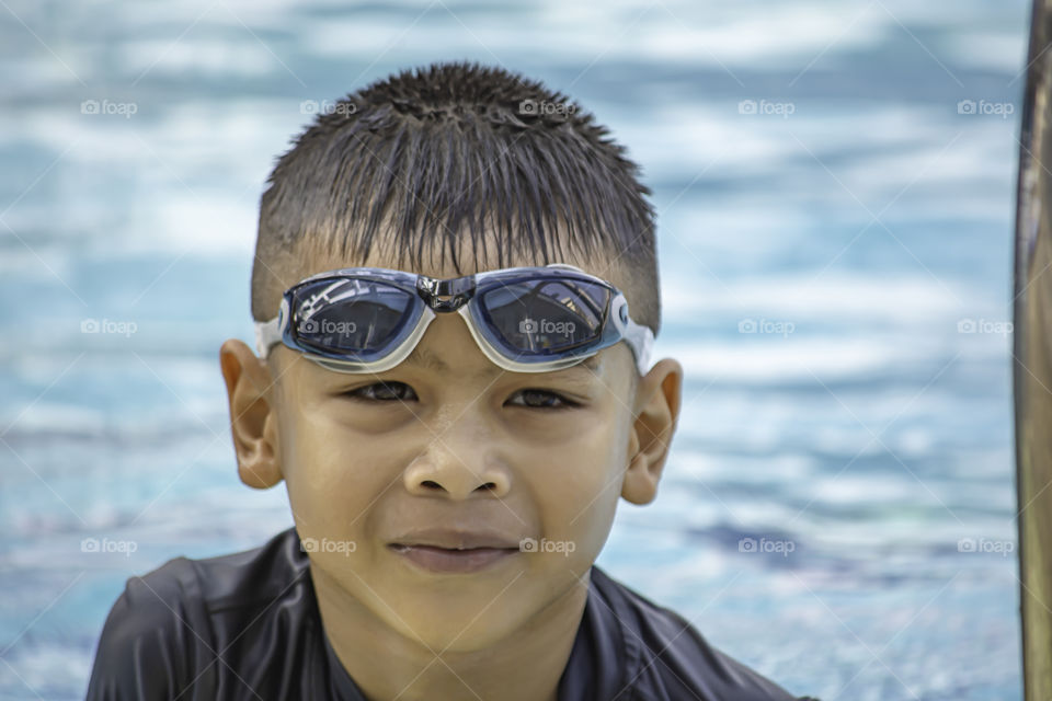 Asean boys are swimming in the pool.