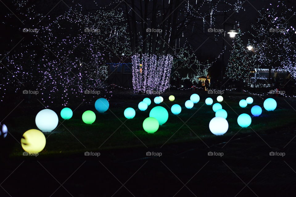 Glowing globe lights on a lawn outdoors at night