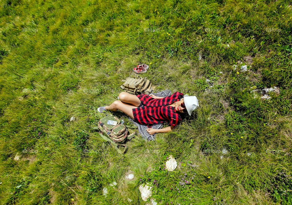 Elevated view of happy woman lying on grass