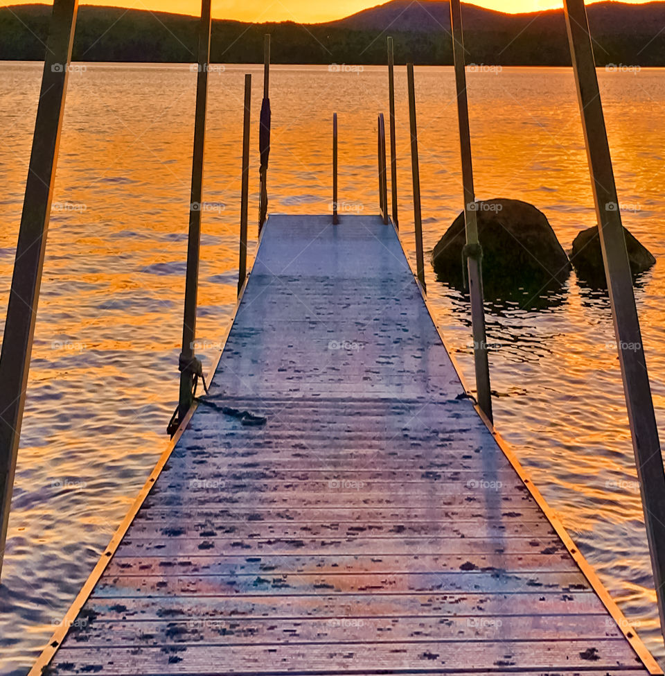 Dock wharf at sunset on the lake