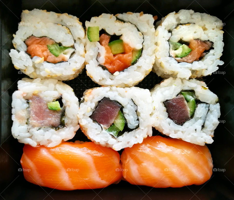 Sushi and Sashimi with tuna, salmon, cucumber and seaweed. Japanese food.
